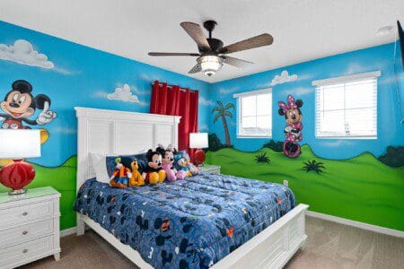 A cozy Mickey Mouse-themed bedroom offering a fun family stay close to the Top Things to Do Near Windsor Island