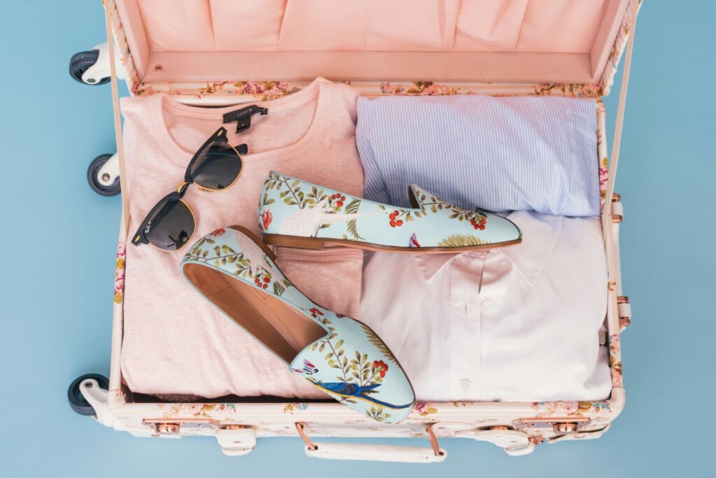 What to pack for Disney World in Orlando – travel essentials like clothes and shoes in a suitcase