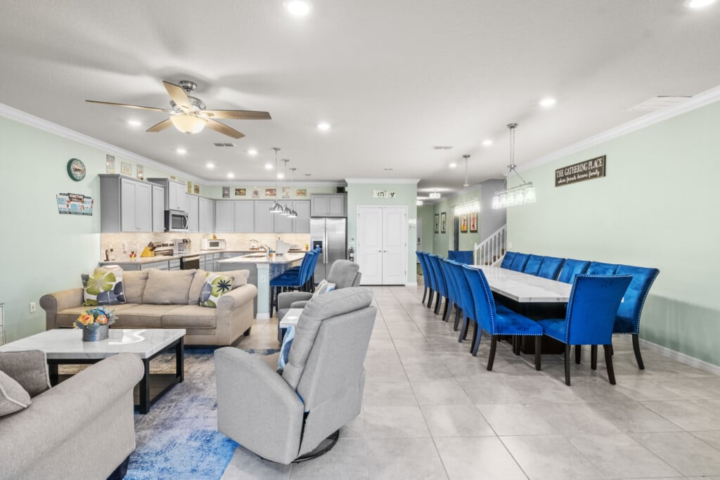 Bright open-plan living and dining area in a Kissimmee vacation home, ideal for families comparing a direct Orlando villa rental vs package holiday.